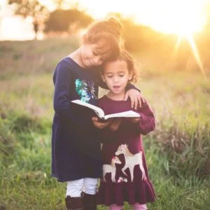 two girls reading the Bible